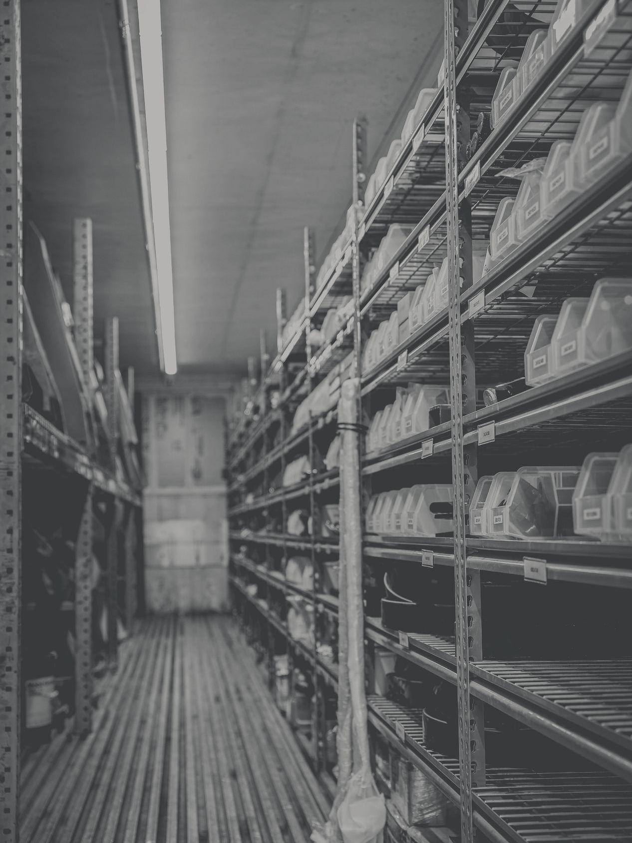 Labelled parts bins on the shelving in ReVolution's parts room.